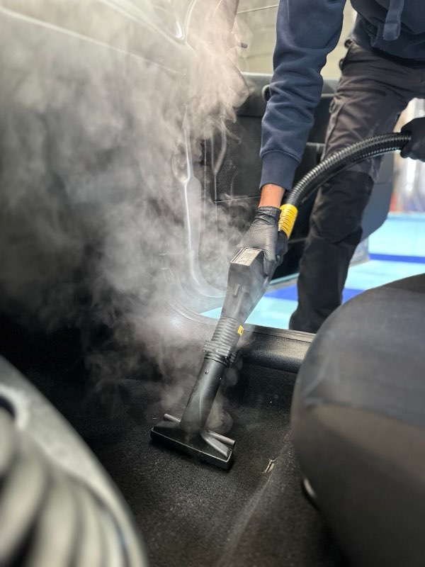 Detailer working on car